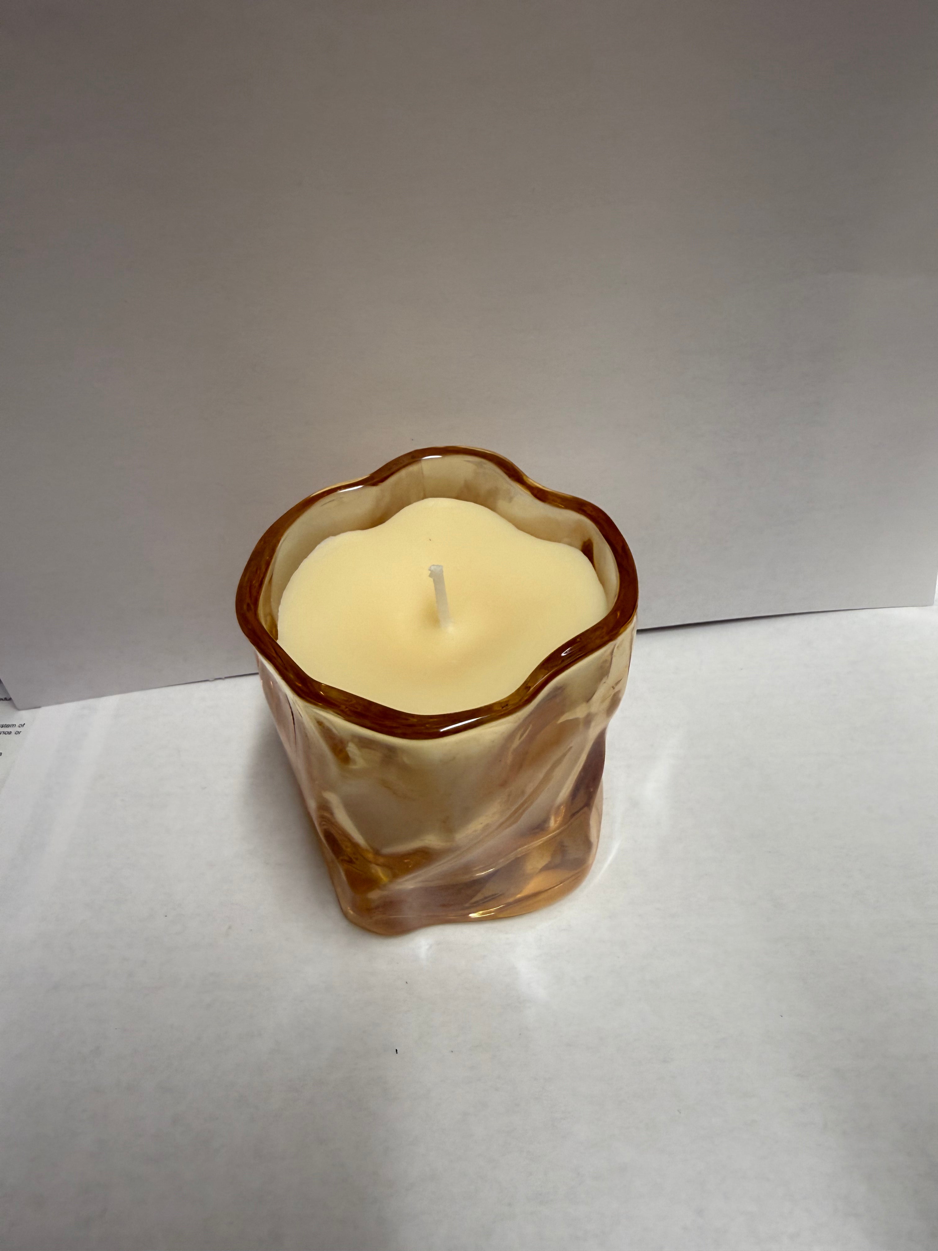 Twisted glass jar filled with soy candle scent of your choice.