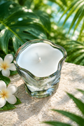 Candle in a lush tropical garden