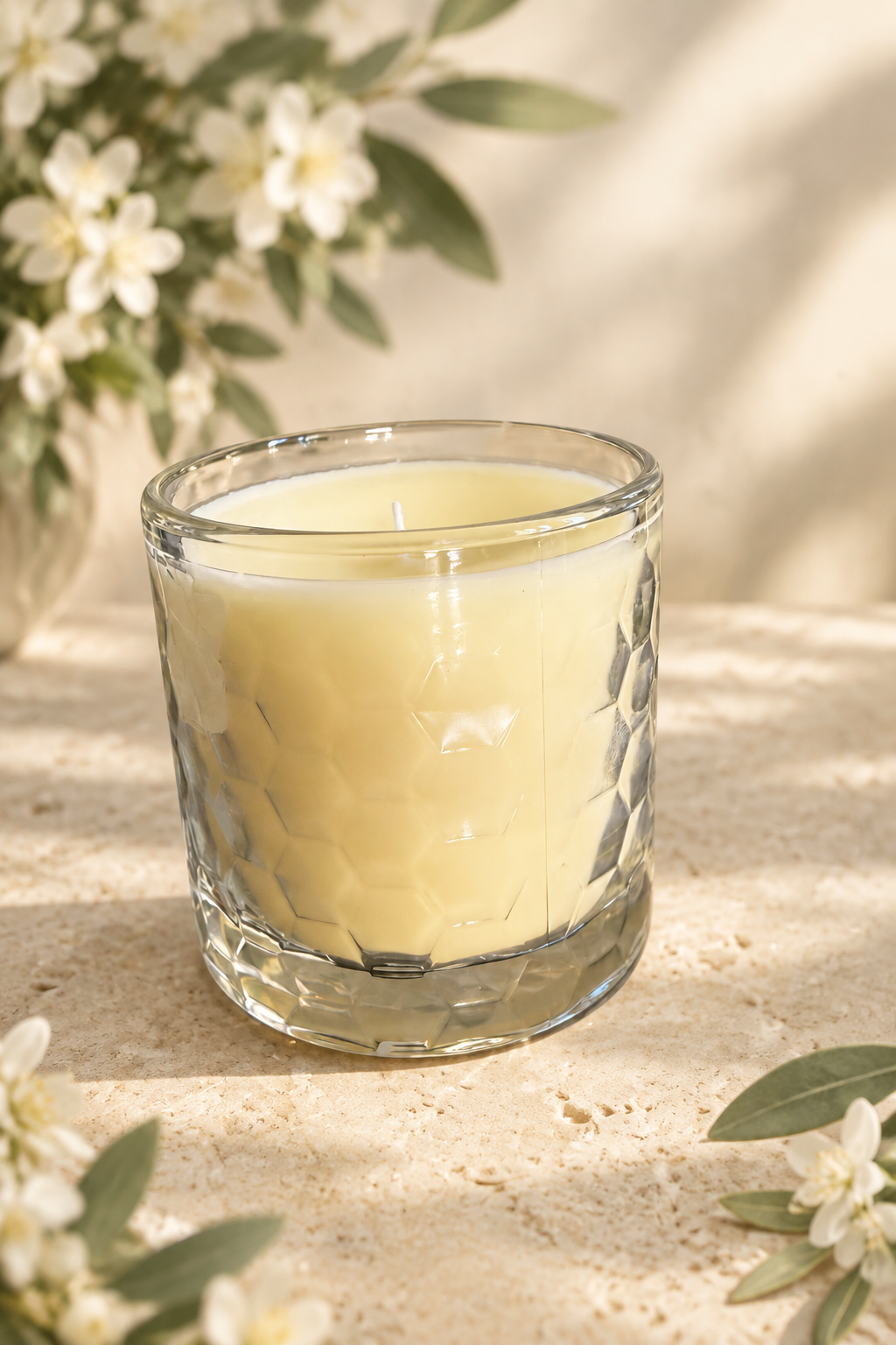 Candle with a soft botanical background