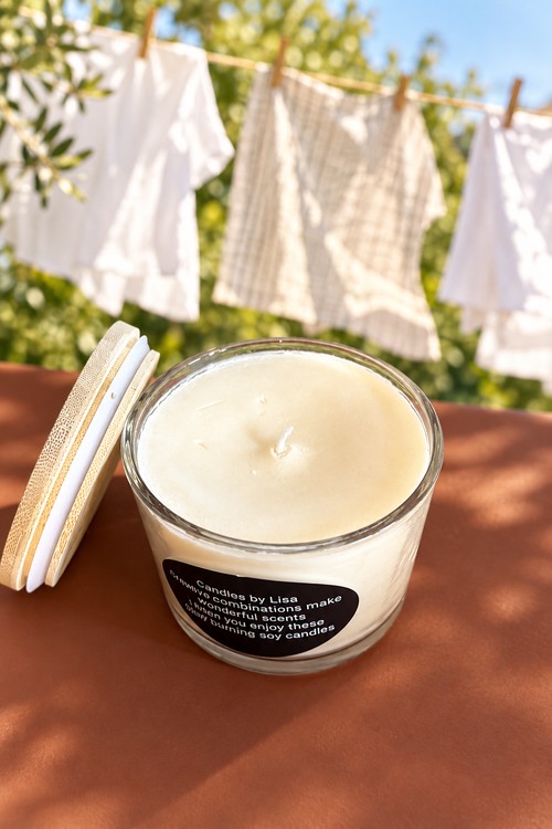 Candle with sun-dried clothes on a clothesline in the background