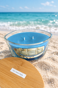 Open candle with ocean background